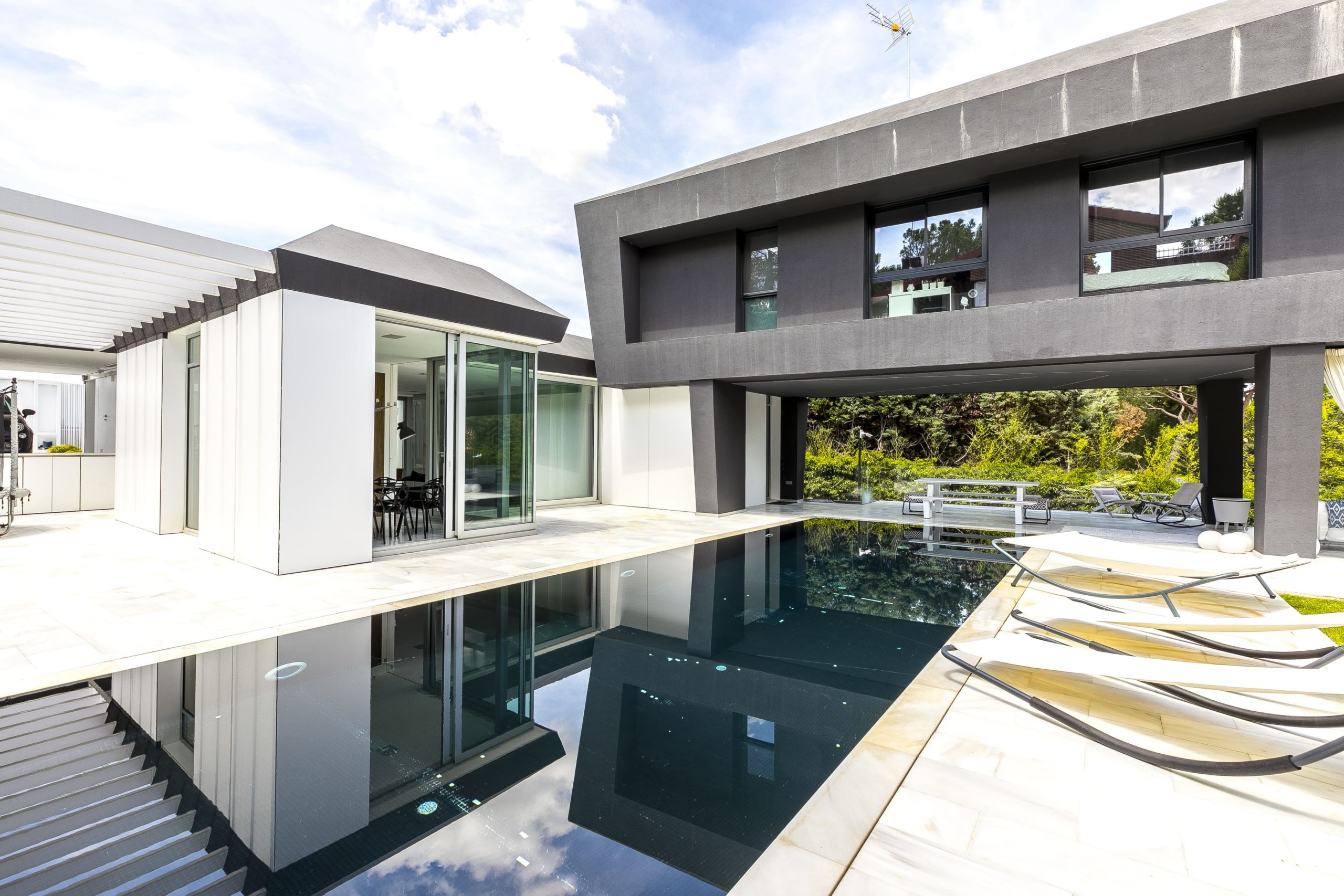 Stunning images of a contemporary chalet featuring 6 bedrooms, an infinity pool, and a beautifully landscaped garden, designed for luxury living and energy efficiency.